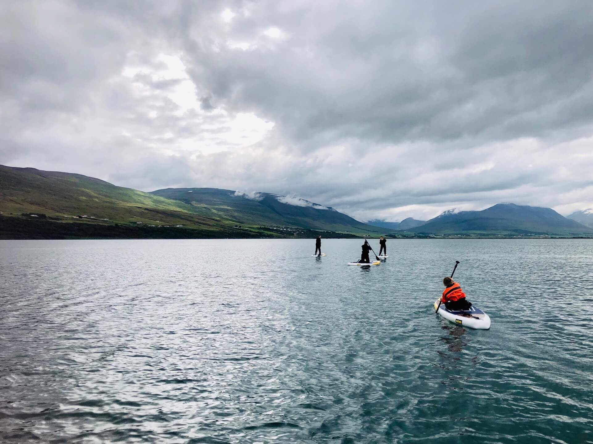 The Winter family stand-up paddleboarding off the coast of Iceland